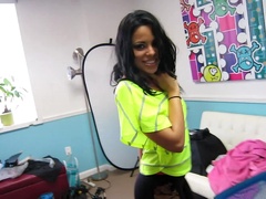 A Latina with an infectious smile is sucking a very large pole